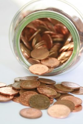 Pennies falling out of a tipped over jar
