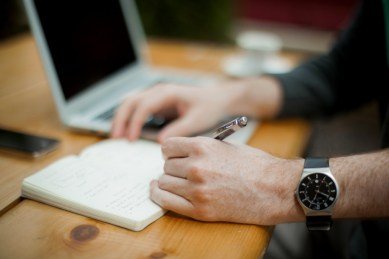 writing in a notepad 